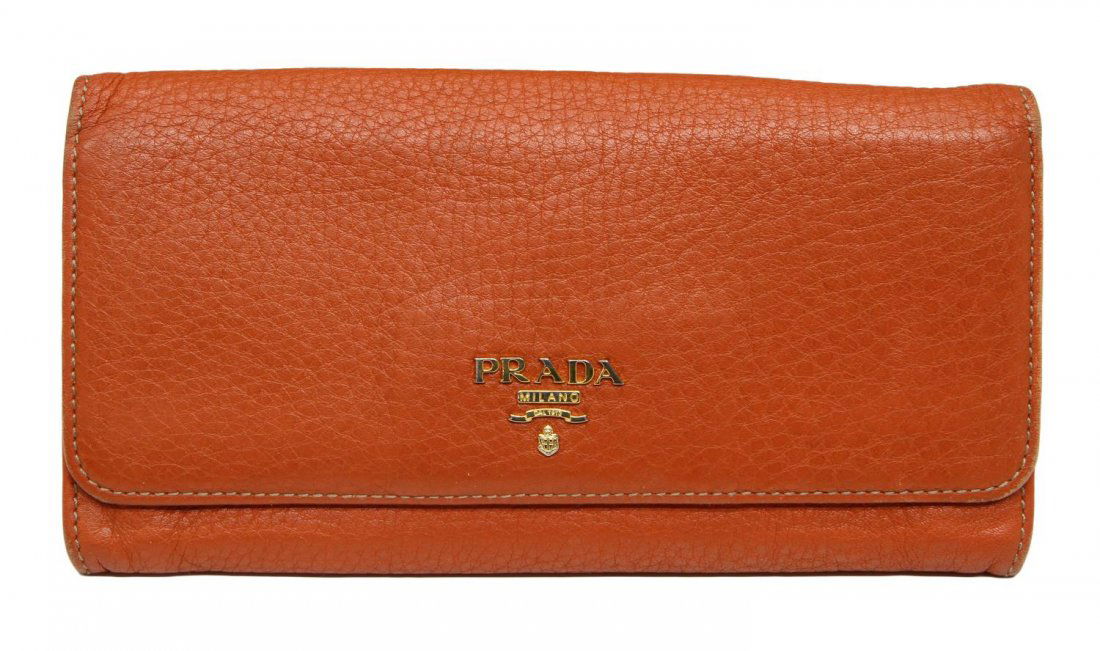 PRADA ORANGE LEATHER LONG WALLET: Prada long wallet in orange leather with fold over front and rear zipped pocket, numerous card slots and zipped pocket to interior, impressed Prada Milano to one side interior flap, Made in Italy on t