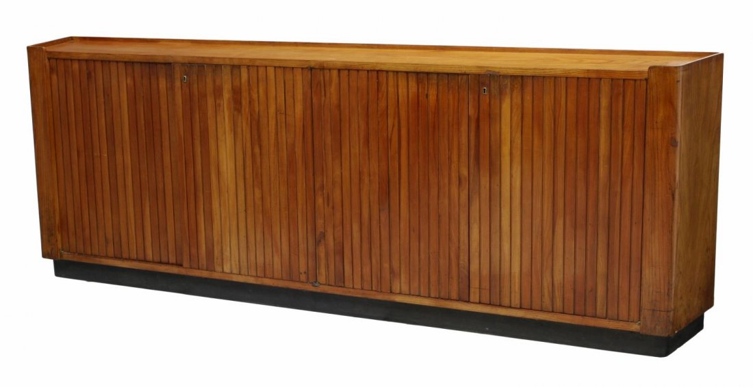 ITALIAN MID-CENTURY MODERN CREDENZA: Italian mid-century modern credenza c, 1960, a long cabinet with angled sides, four doors faced with vertical tongue and grooved slats, interior shelves and two drawers, 33.75"h, 94.5"l, 12"d Start Pr