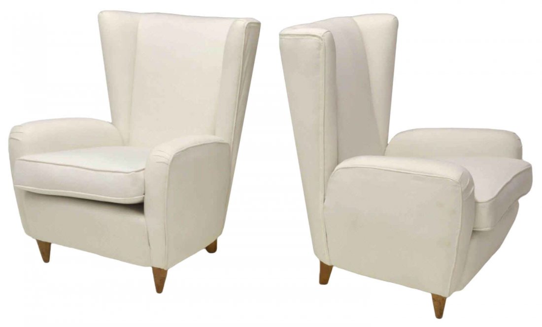 ITALIAN MID-CENTURY MODERN WINGBACK ARM CHAIRS: (pair) Italian mid-century modern wingback arm chairs, c. 1950's, white upholstery, set on four tapered wood supports, 36"h, 27.5"w, 28"d Start Price: $600.00