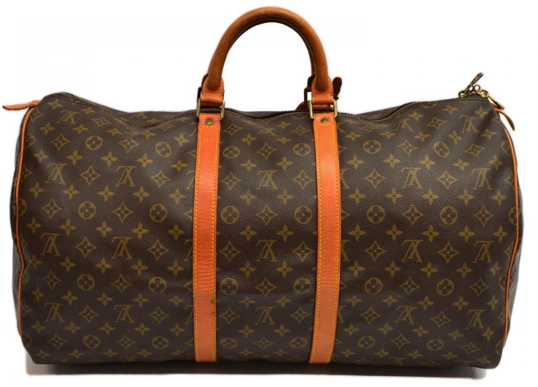 LOUIS VUITTON KEEPALL 55 MONOGRAM CANVAS DUFFLE: Louis Vuitton KeepAll 55 travel/ duffel bag in monogram canvas, leather handles and trim, luggage tag, patination to leather and discoloration to underside as pictured, bag: approx 12"h, 21.5"l, 10"w,
