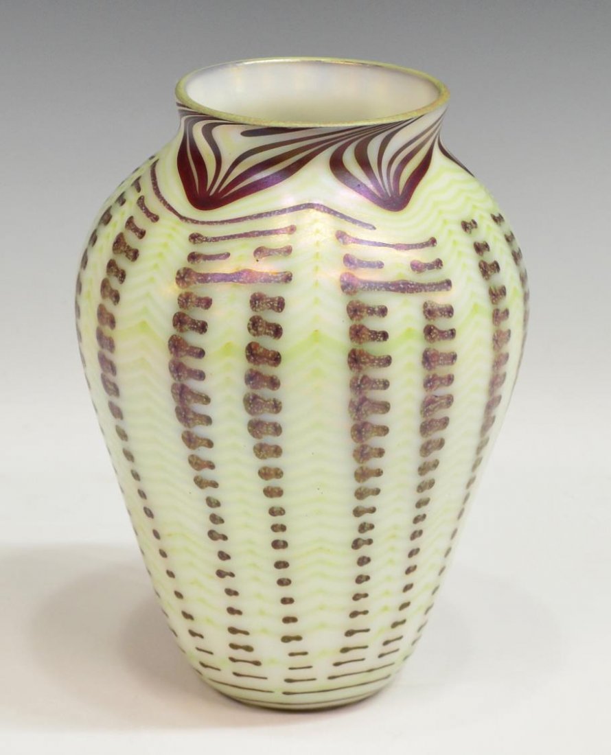 ORIENT & FLUME PULLED FEATHER ART GLASS VASE: Orient and Flume iridescent art glass vase, the baluster form decorated in a pulled feather pattern in green and brown tones, brown shaped accents throughout, acid marked underfoot Orient and Flume 73