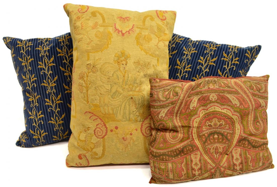 (4) ASSORTED DECORATIVE DOWN FILLED THROW PILLOWS: (lot of 4) Assorted polychrome decorative pillows, comprising: (1) with needlepoint figural scene depicting a woman sitting among birds and flowers, down filled, wear, approx 24.5"h, 17.5"w; (2) blue
