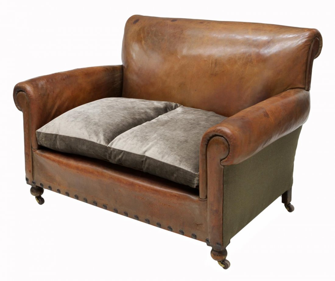 BRITISH LEATHER & VELVET UPHOLSTERED CLUB SOFA: British club sofa or settee, first half 20th c., upholstered in brown leather with two worn velvet upholstered cushions and a bolster, nail head accents at the lower front, bun feet on castors, 35.5"h