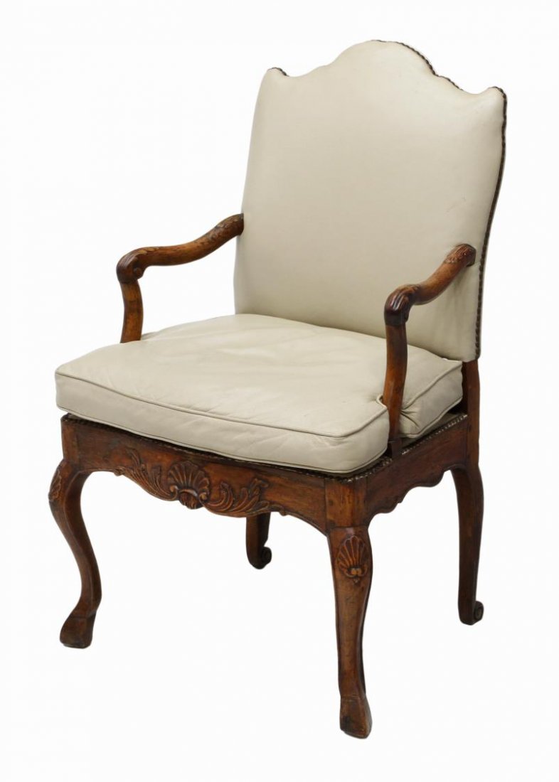 FRENCH LOUIS XV LEATHER UPHOLSTERED FAUTEUIL: French Louis XV style arm chair, late 18th c., the shaped crest over the later leather back and removable seat cushion framed by foliate carved arms, shell carving at the skirt, all rising on cabriole
