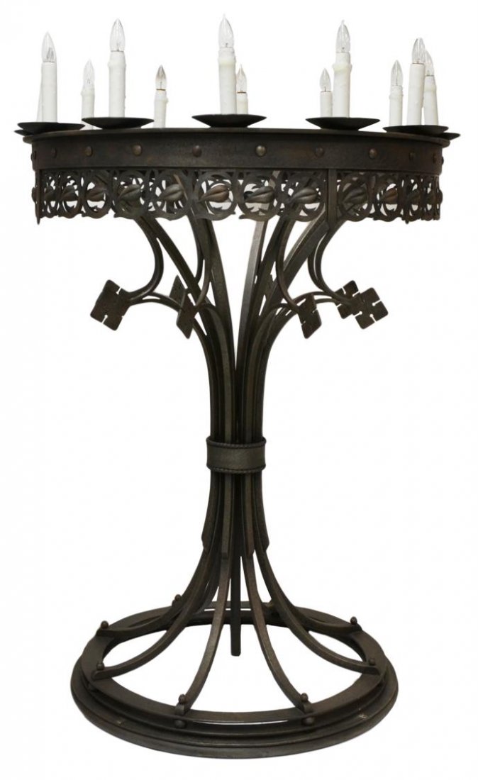 MONUMENTAL GOTHIC STYLE 12-LIGHT TORCHIERE LAMP: Large Gothic style wrought iron torchiere lamp, the circular base rising to a top ring with a pierced and foliated skirt, ring mounted with twelve lights, originally mounted on a circular pedestal as 