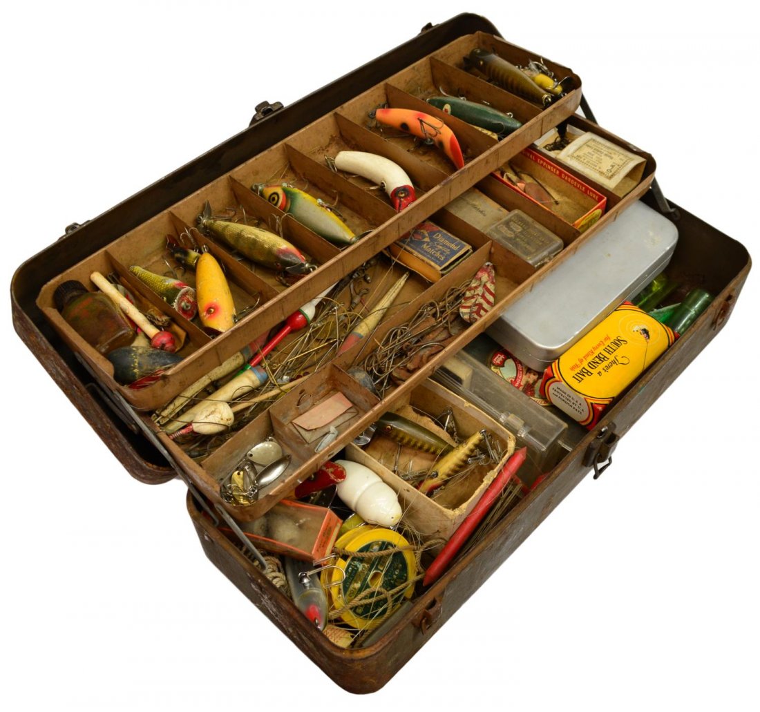 VINTAGE FISHING TACKLE BOX & ACCESSORIES: (lot) Vintage fishing tackle box with substantial quantity of lures and reels, highlights including a Creek Chub Bait Co. 'Pikie', Heddon 'Zara Spook' and other lures, some wood, some with inlaid glas