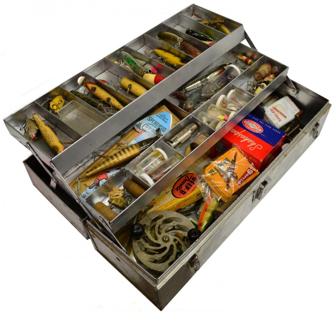VINTAGE FISHING TACKLE BOX & ACCESSORIES: (lot) Vintage fishing tackle box with substantial quantity of lures and reels, highlights including Shakespeare reel, Wood's Manufacturing Co. 'Deep R Doodle', Heddon 'Crazy Crawler', Creek Chub Bait