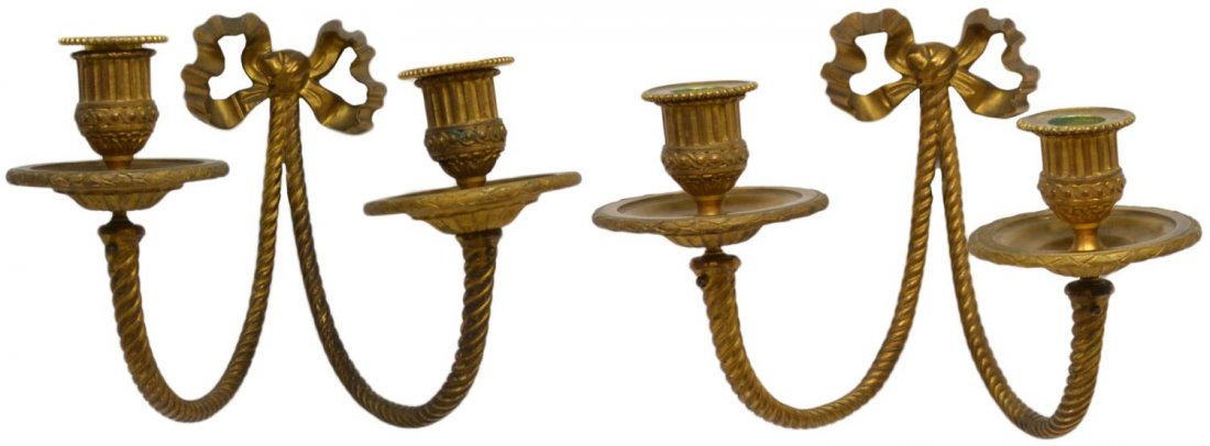 (PAIR) LOUIS XVI STYLE GILT BRONZE CANDLE SCONCES: (pair) Louis XVI style gilt bronze wall sconces, the bow back plate issuing dual spiral arms terminating in ribbed and scrolled candle cups, some oxidation, approx 9.75"h, 12"w, 9.5"d, 8lbs total *Pro