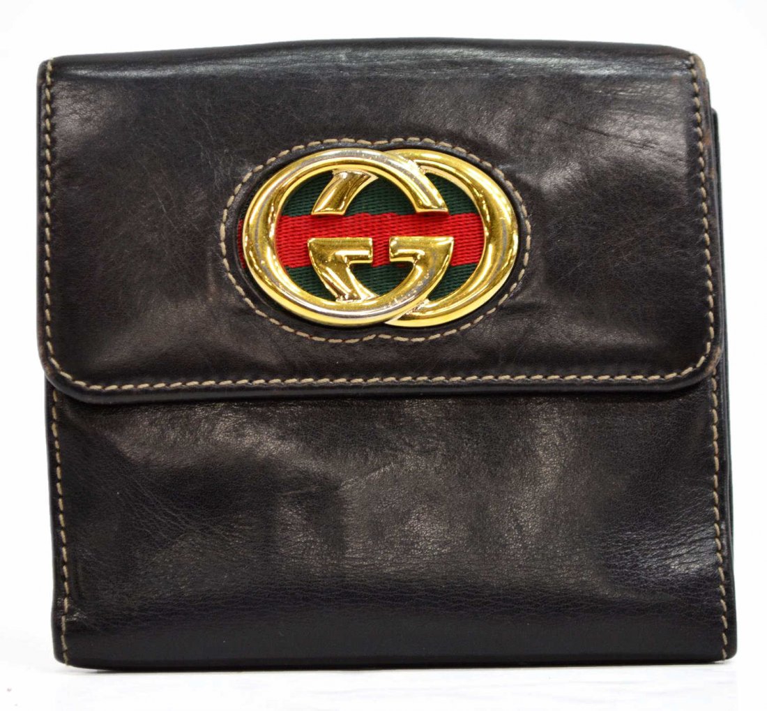 GUCCI DARK BROWN & GILT METAL LOGO WALLET: Gucci leather wallet in dark brown with green and red striped swatch under gilt metal logo hardware, single snap pocket to one side, bill storage and card slots to the snap side, approx. 4.75"h, 5"w, 