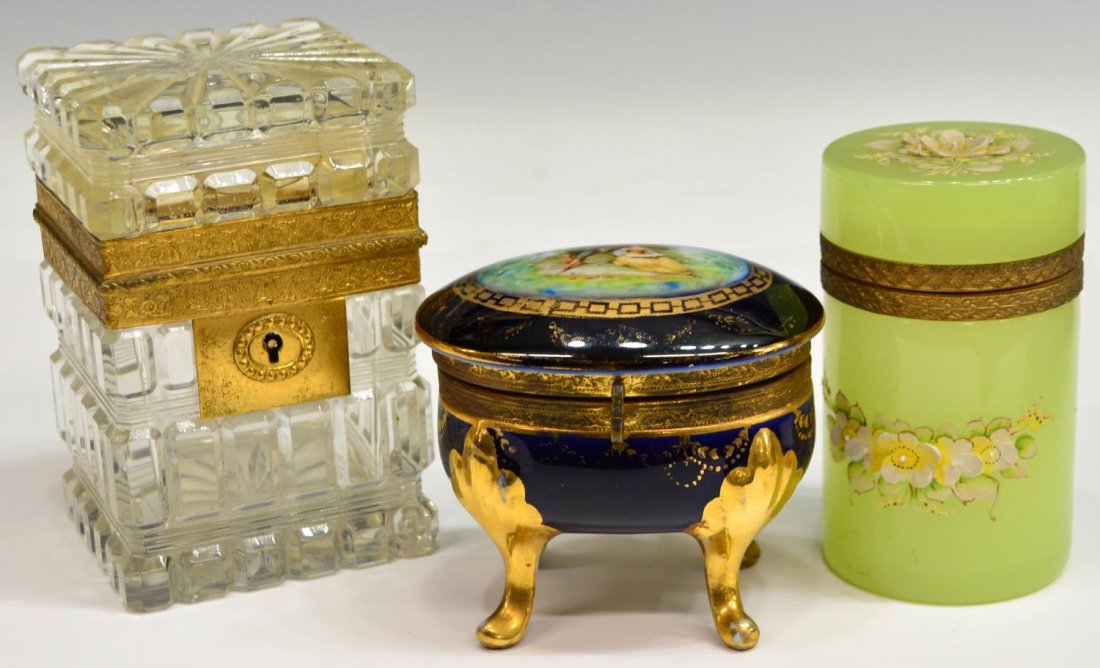(3) ANTIQUE / VINTAGE CONTINENTAL DRESSER BOXES: (lot of 3) Continental dresser boxes, comprising: (1) cut crystal example, early 20th c., of rectangular form, opening with foliated gilt metal border, 4.75"h, 3"w, 3"d; (1) porcelain example, early 2
