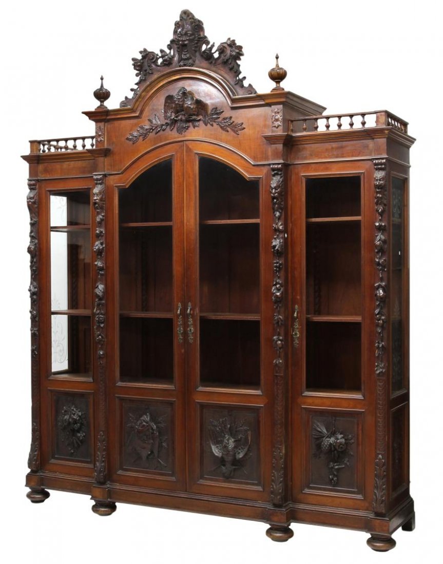 SUPERB ITALIAN RENAISSANCE REVIVAL BOOKCASE: Italian breakfront bookcase, 19th c., an arched, mask carved cornice over relief carved lovebirds, two central doors with upper panels of glass, lower panels with carved game birds and fish, flanking 