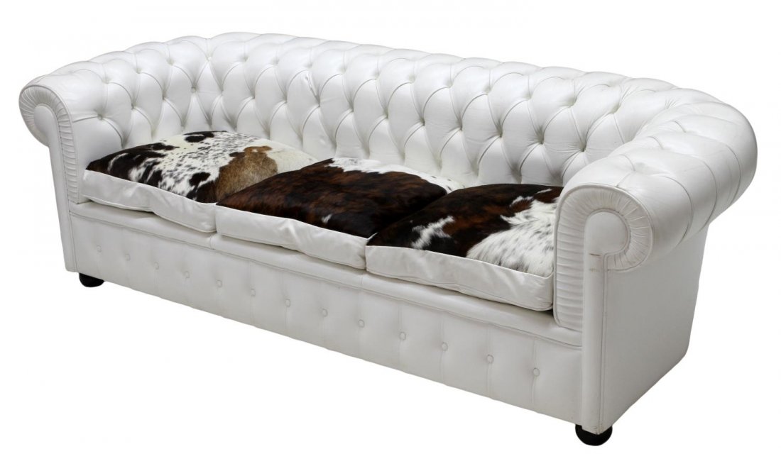 ITALIAN BUTTONED WHITE LEATHER & COWHIDE SOFA: Italian white leather buttoned sofa, 20th c., rolled back and arms, three loose cushions in spotted cowhide, raised on bun feet, 26"h, 84"l, 30.5"d Start Price: $500.00