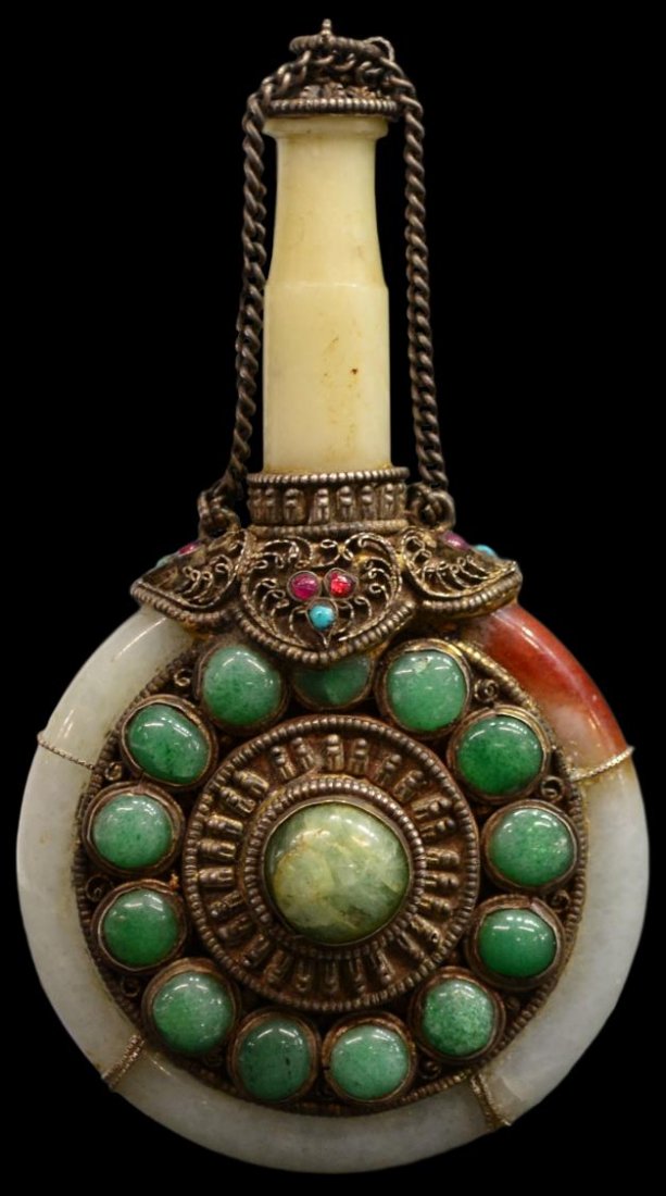 TIBETAN / MONGOLIAN JADE & METAL BOTTLE: Tibetan/Mongolian jade and metal bottle, formed by a jade bangle encircling green cabochons within a gilt metal setting below a filigreed metal collar with further inlay and surmounted by a long jade 
