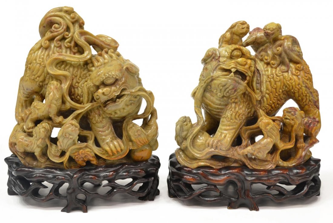 (2) LARGE CHINESE CARVED SOAPSTONE FIGURAL GROUPS: (pair) Large Chinese carved soapstone figures, mid 19th c., modeled as a larger mother foo lion with foo lion cubs, rising on a fitted carved wood stand, both with glue restorations, largest: approx 1