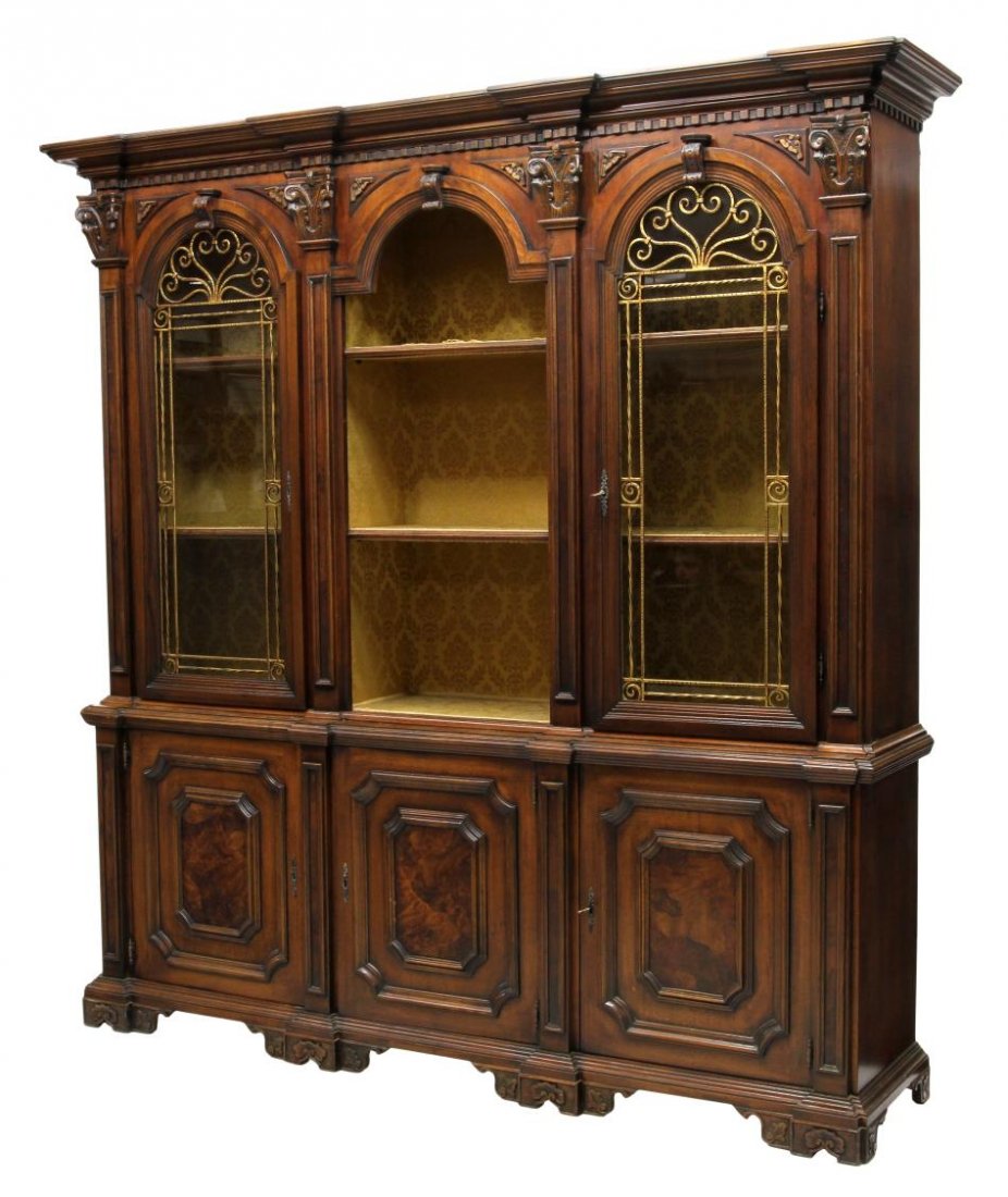 LARGE & ORNATE ITALIAN WALNUT DISPLAY CABINET: Italian breakfront walnut display cabinet, 20th c., the stepped cornice with dentil molding over two arched glass front doors with ornate metal grates flanking a central arched open shelved display ar
