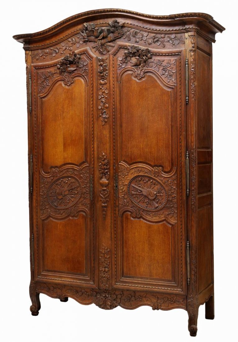 HIGHLY CARVED LOUIS XV 18TH C. WEDDING ARMOIRE: French provincial Louis XV oak wedding armoire, 18th c., with substantial carving, the cornice over two relief carved lovebirds within a floral wreath, two doors with carved birds, florals and tribute