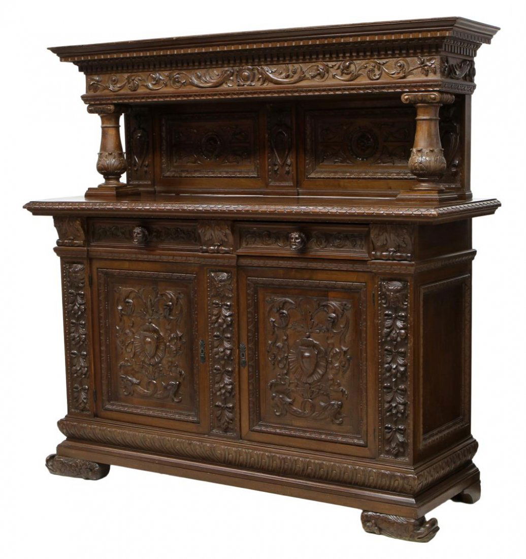 ITALIAN RENAISSANCE REVIVAL WALNUT SIDEBOARD: Italian Renaissance Revival carved walnut sideboard, early 20th c., rectangular back panel with foliate carved edges, bulbous supports, over two frieze drawers with figural pulls, two foliate carved f