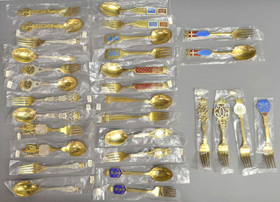 (30) A. MICHELSEN GILT STERLING COMMEMORATIVE SETS: (lot of 30) A large collection of Danish parcel gilt sterling silver commemorative spoons and forks, varied years, A. Michelsen, (Anton Michelsen, Denmark, 1809-1877), Copenhagen, many with enameled a