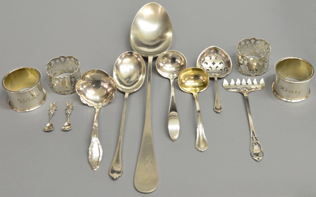 (13)STERLING SILVER SERVICE FLATWARE, NAPKIN RINGS: (lot of 13) Sterling silver, an assorted group including (4) napkin rings, one set engraved 'Claire', the other pierced and monogrammed, (2) salt spoons, each surmounted by a cherub, (3) small ladles,