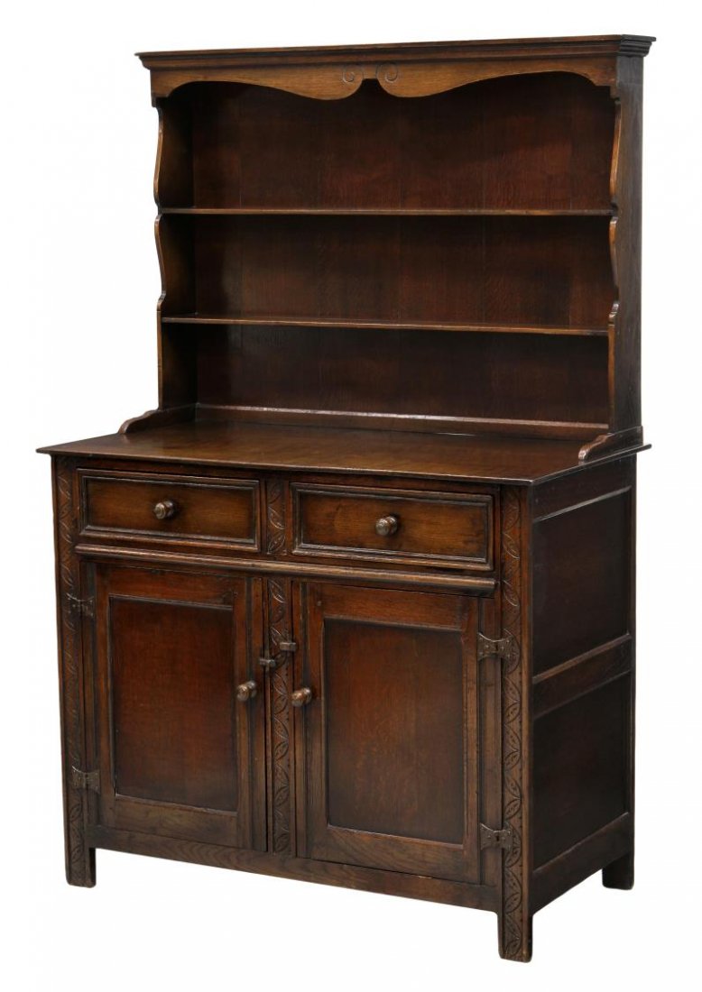DIMINUTIVE OAK WELSH DRESSER: Diminutive oak Welsh dresser, 20th c., the back with a stepped cornice over display shelves, the lower cabinet with two drawers over two doors, rising on block feet, 60"h, 39"w, 19.5"d Start Price: $2