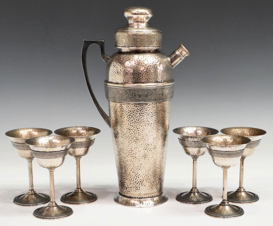 (7) AMERICAN ART DECO HAMMERED COCKTAIL DRINKS SET: (set of 7) Art Deco hammered silver plate cocktail set, Apollo, Bernard Rice's Sons Inc., Etchardt Design, Pat. Apr 22' 24, comprising: (1) shaker, 13.5"h; (6) stems, 5"h; 4lbs total Start Price: $80.