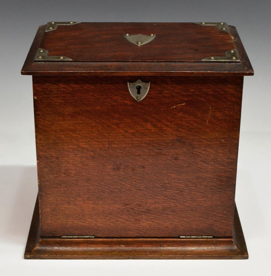 EDWARDIAN OAK LETTER BOX: Edwardian oak letter box, early 20th c., the hinged top with metal corner accents, a central shield name plate, opening to the fitted interior with pen holder, letter slots and a writing surface at th