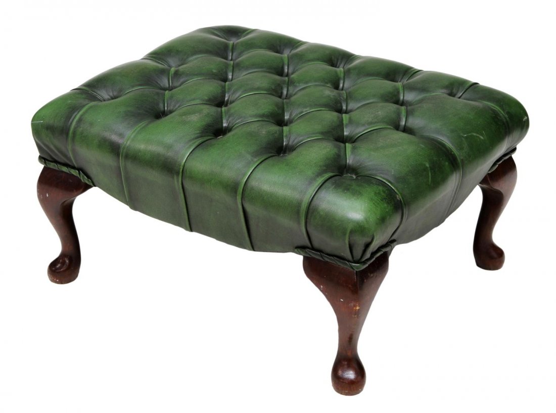 BUTTONED LEATHER FOOTSTOOL: English green buttoned leather footstool with short cabriole legs, 12.25"h, 22.75"w, 19"d Start Price: $80.00