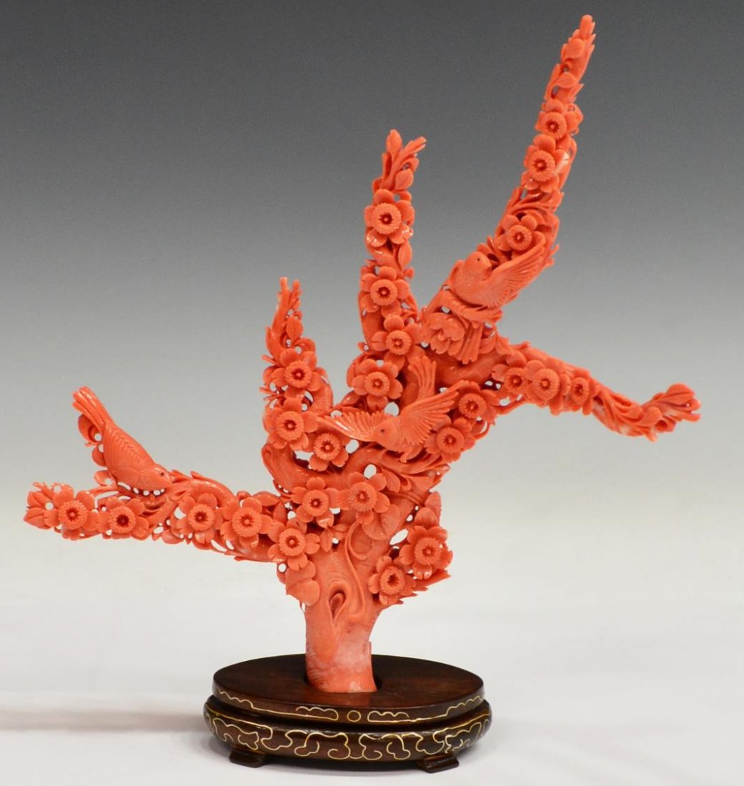 CHINESE CARVED RED CORAL, BLOOMING TREE & BIRDS: Chinese fully carved red coral group, three birds perch upon the branches of a tree of blooming flowers, affixed to carved wood base inlaid with gilt wire, statue: 8.25"h, overall: 9"h, .75lb *Provena