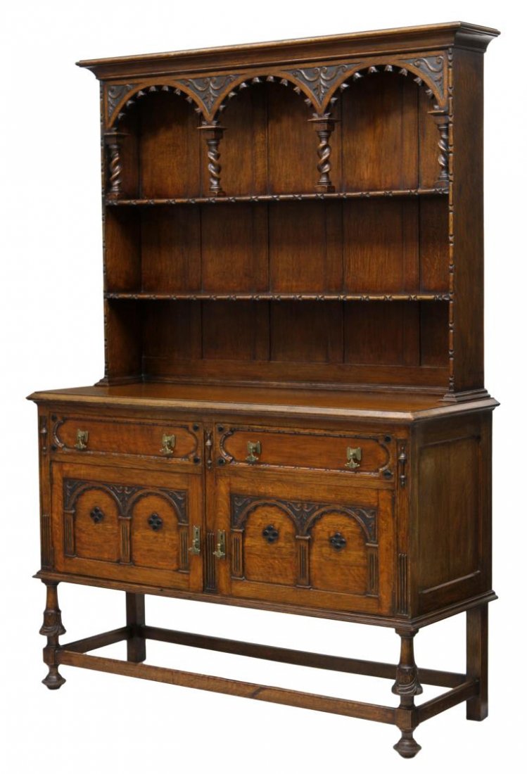 BRITISH GOLDEN OAK DISPLAY BACK SIDEBOARD: British golden oak sideboard, 1930's, a stepped cornice over the arcaded display back with twist columns and shelves over the rectangular cabinet top with two drawers over two doors, raised on short c