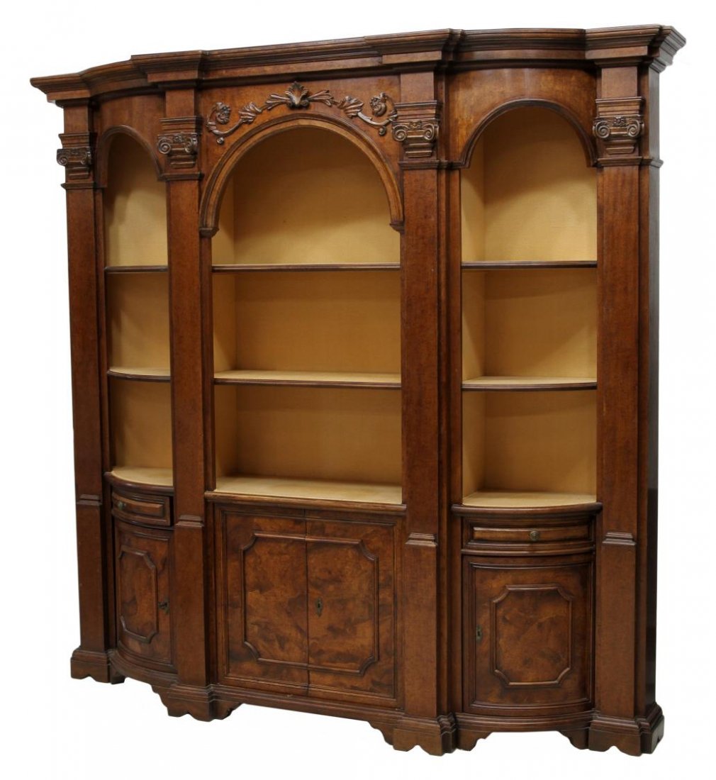 ITALIAN THREE PART BOOKCASE: Large Italian three part bookcase, 20th c., a stepped protruding cornice over the center with shelves and lower drawers, flanking curved end cabinets with shelves, a drawer and door, set on conforming