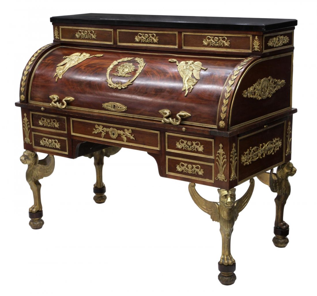 ORNATE FRENCH EMPIRE REVIVAL CYLINDER DESK: French Empire Revival cylinder desk, early 20th c., extravagantly decorated with figural and foliate ormolu including trumpeting angels, masks, putti, winged lions, a marble top with three frieze draw