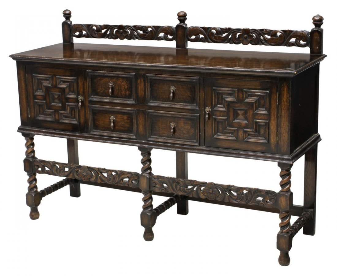 ENGLISH OAK CARVED SIDEBOARD, C. 1920'S: English oak sideboard, 1920's, having a foliate carved pierced back rail, two doors flanking two drawers with one fitted as a silver drawer, a foliate pierced carved skirt, rising on block and twist l
