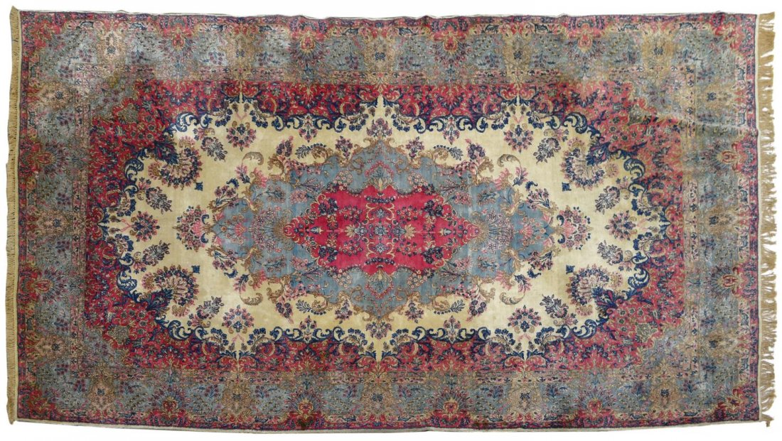 PERSIAN HAND TIED LAVAR KERMAN RUG, 16'3"x9'8": Persian hand tied Lavar Kerman rug, c. 1930, decorated with blooming branches and foliated motif, executed in pink, blue, white and brown tones, some stains, discoloration, minor hole, approx 16'3"l, 