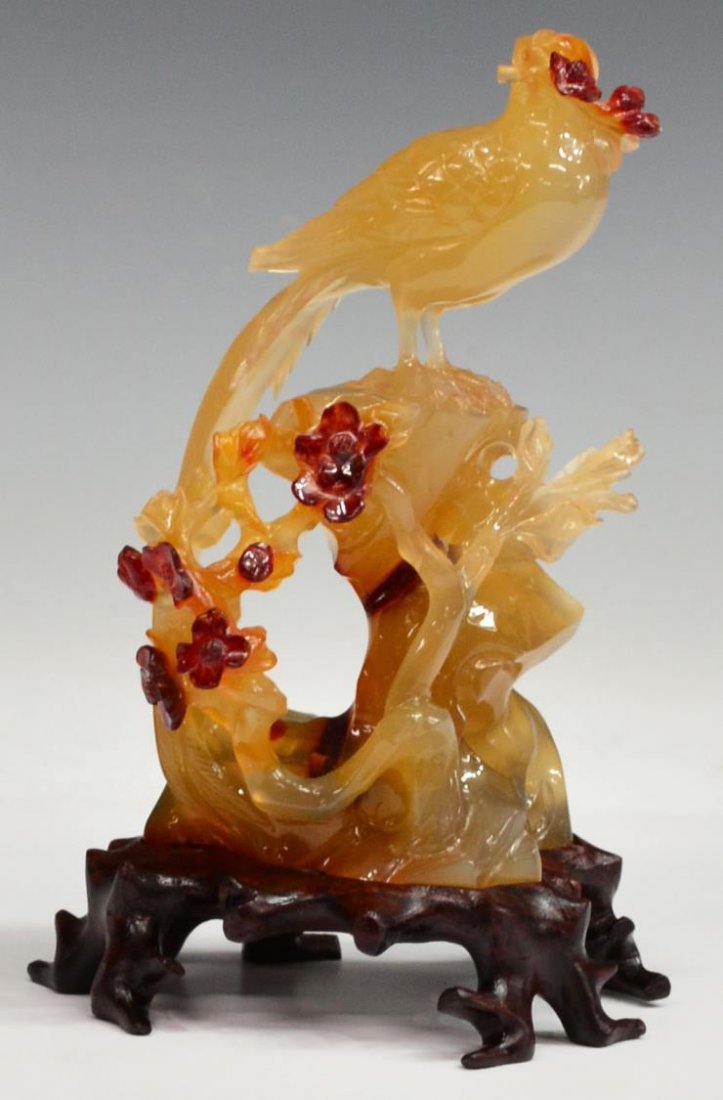 CHINESE FIGURAL AGATE CARVING, BIRD OF PARADISE: Chinese figural Carnelian carving, a Bird of Paradise on rocky perch, fronted by flowering branches, carved wood base, retaining box, figure: 5"h, on stand: 6"h, boxed: 3.75"h, 7.75"l, 5.25"w, 2lb tot