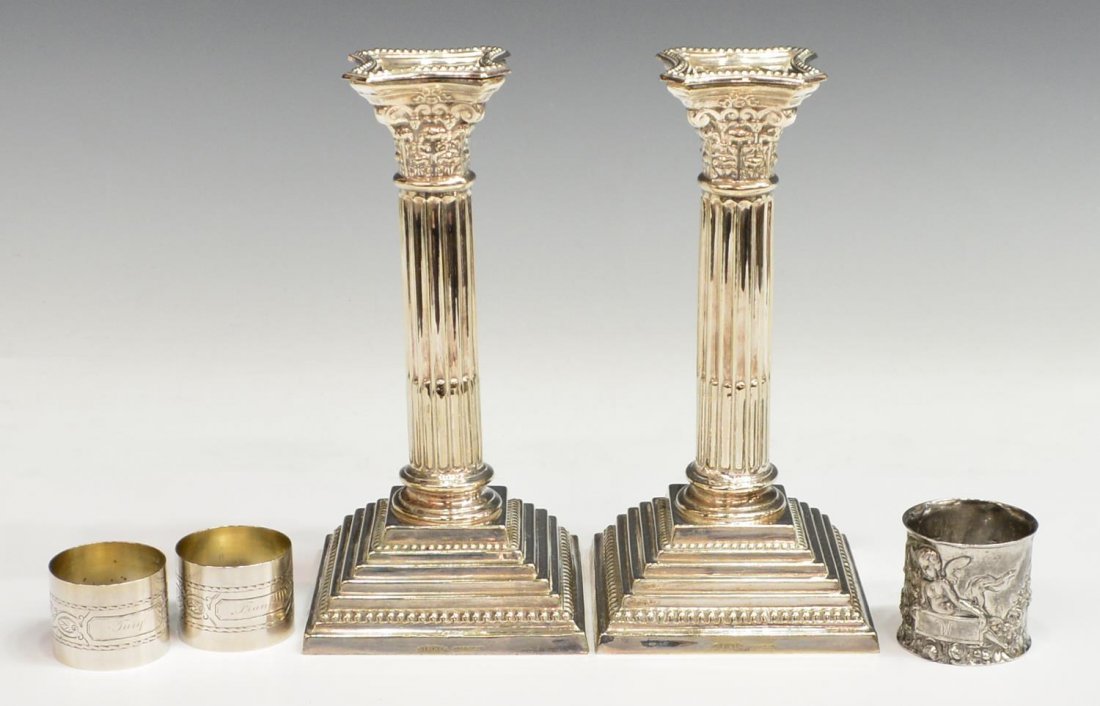 ENGLISH COLUMNAR SILVERPLATE CANDLESTICKS: (pair) English stepped silver plate candlesticks of columnar form, each fluted stem beneath a Corinthian capital, weighted, 8"h; together with (3) napkin rings, one repousse with winged cherub, monogr