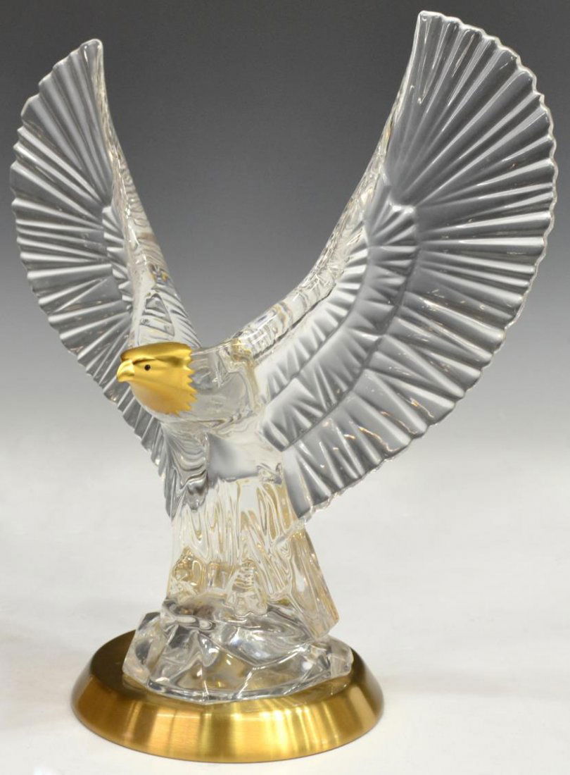 GERMAN PARCEL GILT ART CRYSTAL EAGLE: German parcel gilt and colorless crystal figure, modeled as an eagle, acid marked 1989 FM underfoot, retaining Made in Germany sticker, set on a gilt metal base, overall: 11"h, 10"w, 5.25"d, 5.5lbs *P