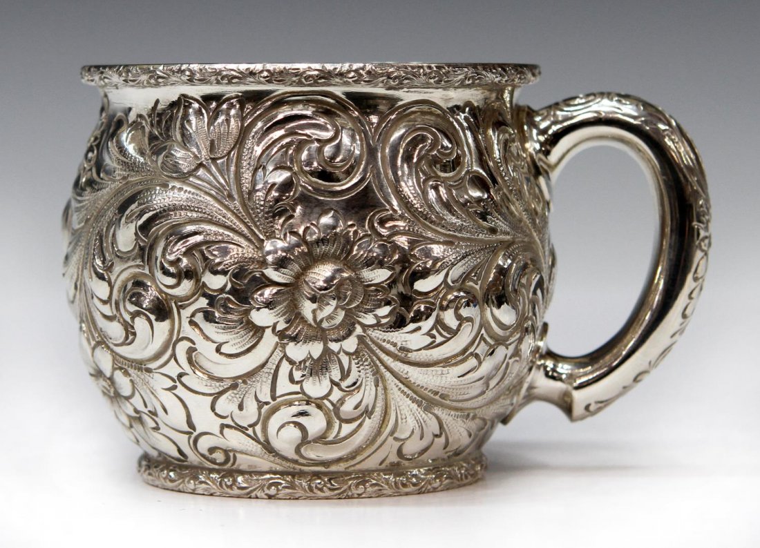 THEODORE B. STARK REPOUSSE FLORAL STERLING CUP: Theodore B. Stark sterling silver cup, New York, handled mug with profuse repousse floral decor, 3"h, 4.5"w (to handle), 8.45ozt Start Price: $80.00