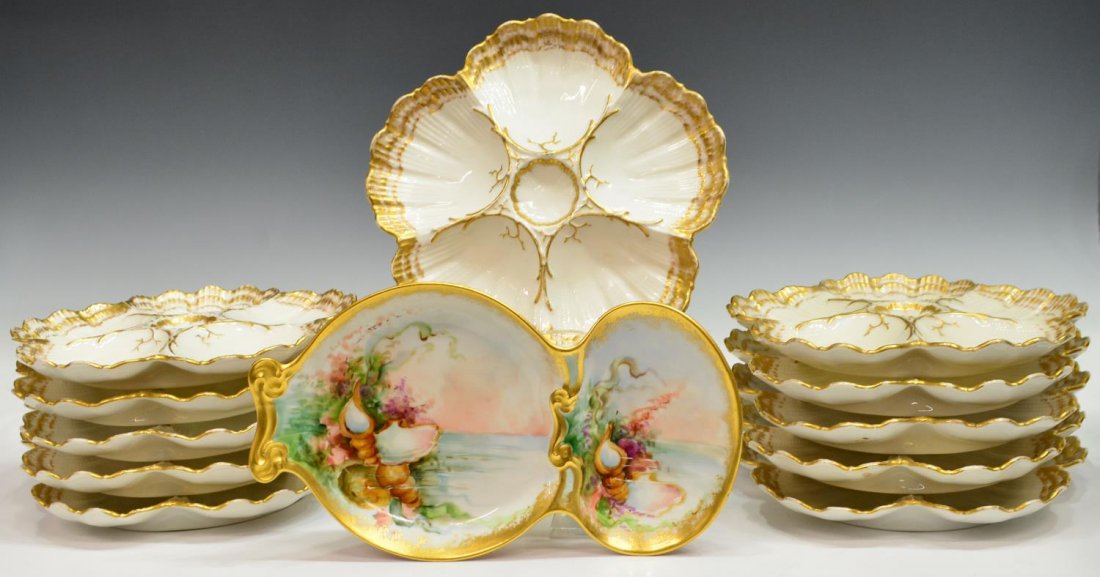 (12) FRENCH GILDED PORCELAIN OYSTER PLATES & DISH: (lot of 12) Collection of French gilt porcelain serviceware, comprising: (11) oyster plates, gilt accents on a white ground, retailed by Gilman Collamore, one with old staple restoration as pictured, 