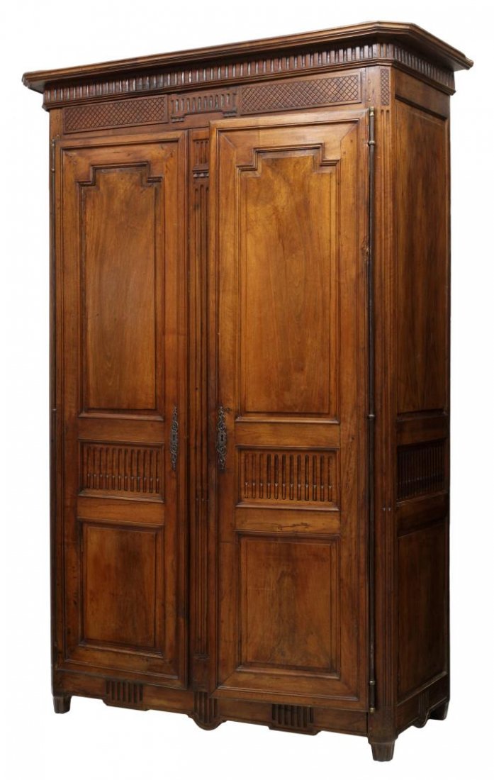 FRENCH LOUIS XVI ARMOIRE, C. 1780: French Louis XVI style walnut armoire, c. 1780, a protruding cornice over the groove carved frieze, full length exterior hinges on the two doors, tapered reduced height legs, peg joinery, restorations
