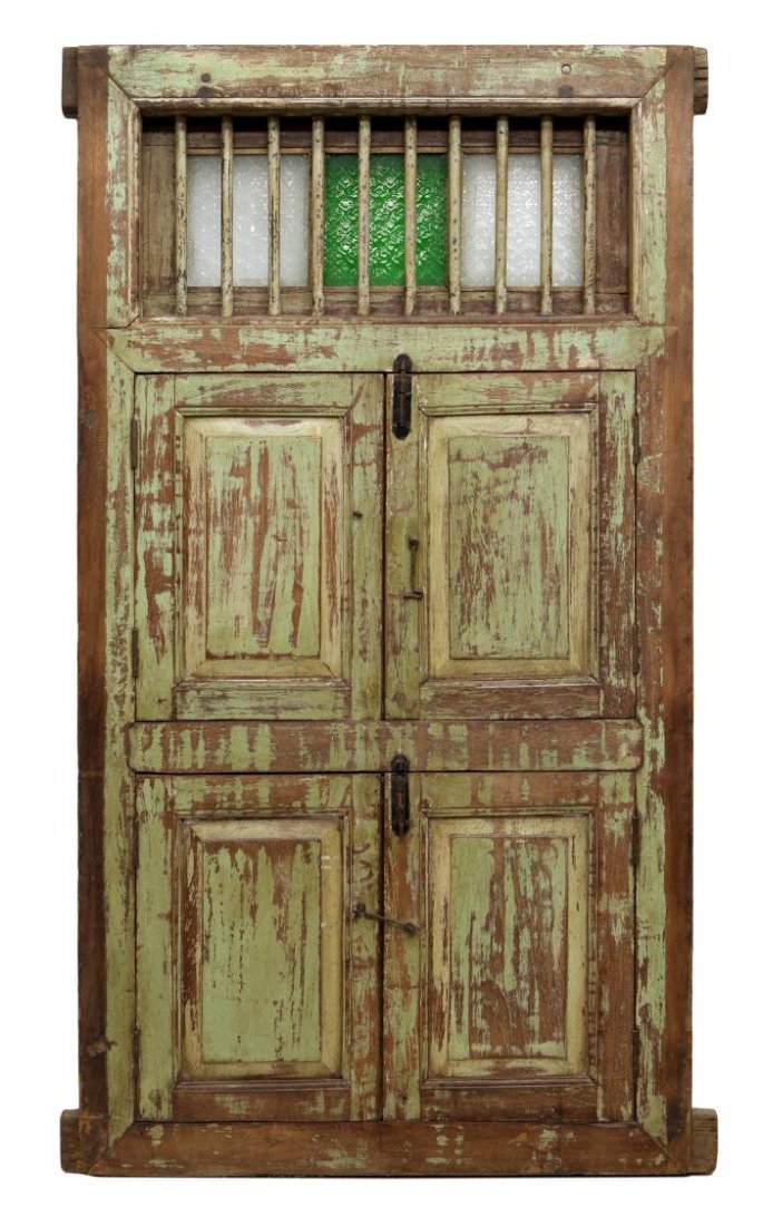 PORTUGUESE COLONIAL IRON BAR WINDOW: Portuguese Colonial polychrome window, 19th c, the upper section with vertical bars over stained and clear glass panels, the lower section with two sets of lower doors opening to vertical bars, mortis