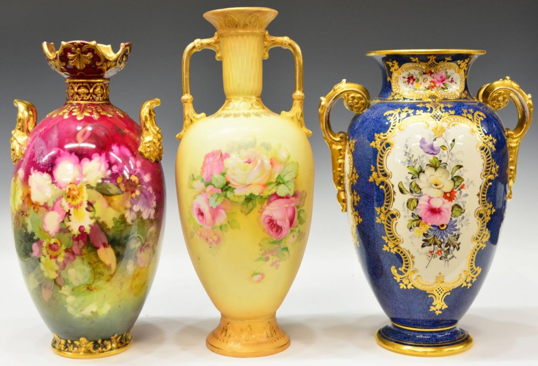 (3) GERMAN ROYAL BONN & AUSTRIAN PORCELAIN VASES: (lot of 3) Group of Continental vases, comprising: (1) German Royal Bonn, reserves of hand painted floral sprays enclosed by gilt enamel scrolled borders on a blue ground, gilt handles with flower hea