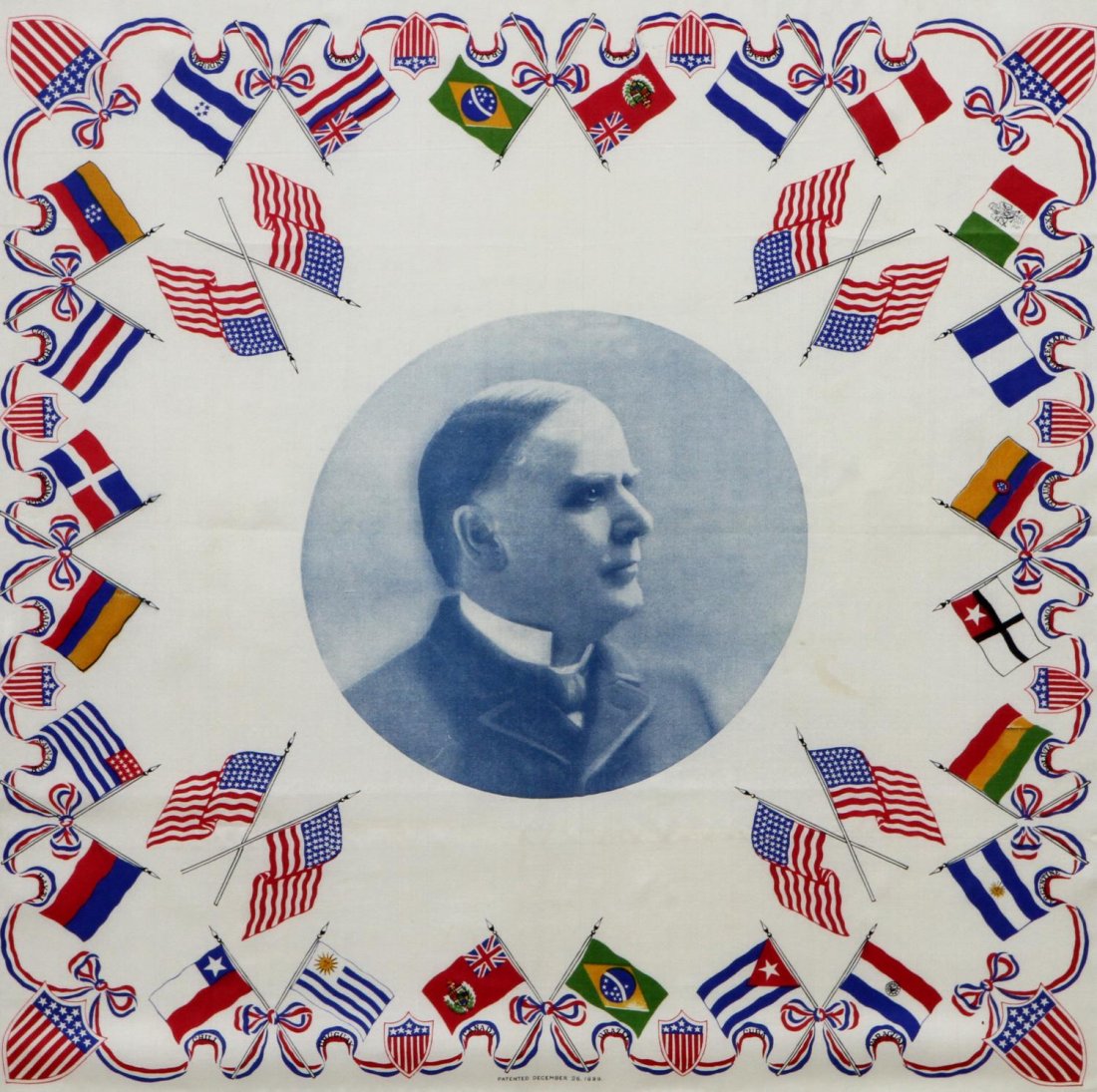 PRESIDENT WILLIAM McKINLEY FRAMED 1899 POSTER: Framed poster on fabric, President William McKinley surrounded by US and Latin American flags, lower center patent date of December 26, 1899, frame with some finish loss, conservation framed, UV glass