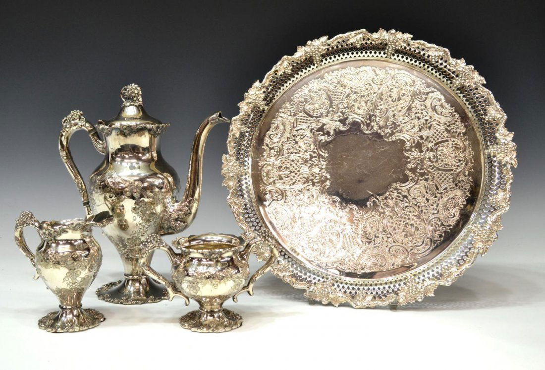 (4) EGW & S SILVER PLATE GRAPE MOTIF TEA SERVICE: (set of 4) EGW & S silver plate tea, hand chased in a leafy grape bunch motif, comprising (1) teapot, (1) handled sugar and (1) cream pitcher, together with a similarly decorated English tray of circu