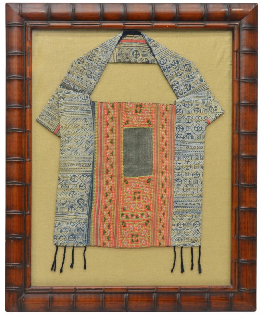 FRAMED CHINESE HMONG ETHNIC MINORITY BABY CARRIER: Framed Chinese Hmong ethnic minority baby carrier, finely embroidered with various geometric patterns and colors including blue, orange, green and black, framed: 33"h, 27"w, 12.25lbs Start Price: $100