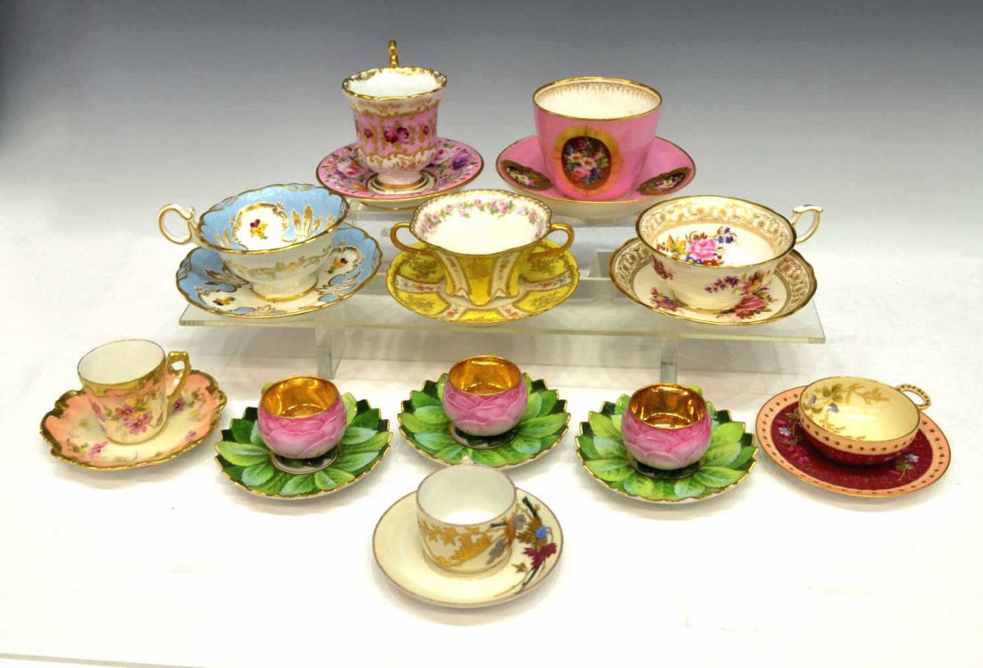 (22) CONTINENTAL PORCELAIN TEA CUPS & SAUCERS: (11 sets) Collection of Continental porcelain polychrome teacups and matching saucers, including (1) G.D. & C. Limoges, flowers with gilt enamel detail on a ruby ground, (1) Limoges France, pink and p