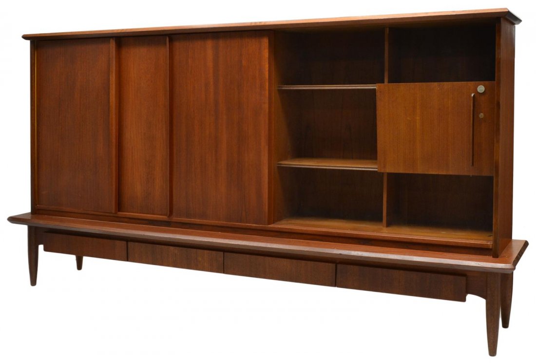 HILKER MODELL GERMAN MID-CENTURY MODERN SIDEBOARD: German mid-century modern teakwood sideboard, Hilker Modell, three doors and sliding glass door on a rectangular case, open to an interior fitted with shelving and a fold out bar, four lower drawers, 