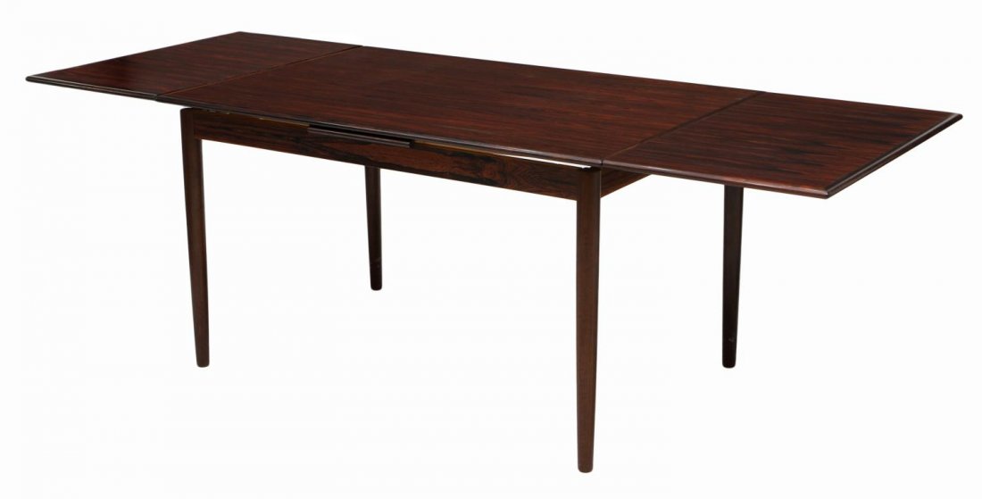 DANISH MID-CENTURY NIELS MOLLER ROSEWOOD TABLE: Danish mid-century modern rosewood draw leaf dining table, design by Niels Otto Moller (Denmark, 1920-1981), rectangular with leaves opening to 90"l, rising on tapered turned legs, leaves closed: 29.5