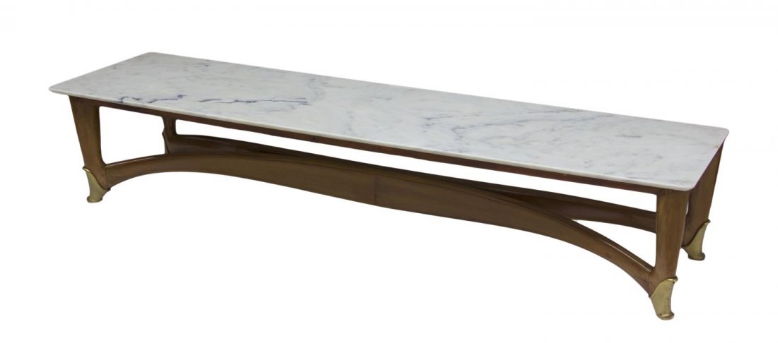 ITALIAN MID-CENTURY MODERN COFFEE TABLE, BUFFA: Italian mid-century modern long top coffee table, design by Paolo Buffa (Italian, 1903-1970), the rectangular marble top raised on stretcher joined wide tapered legs on brass shoe feet, 14.5"h, 74.5"l