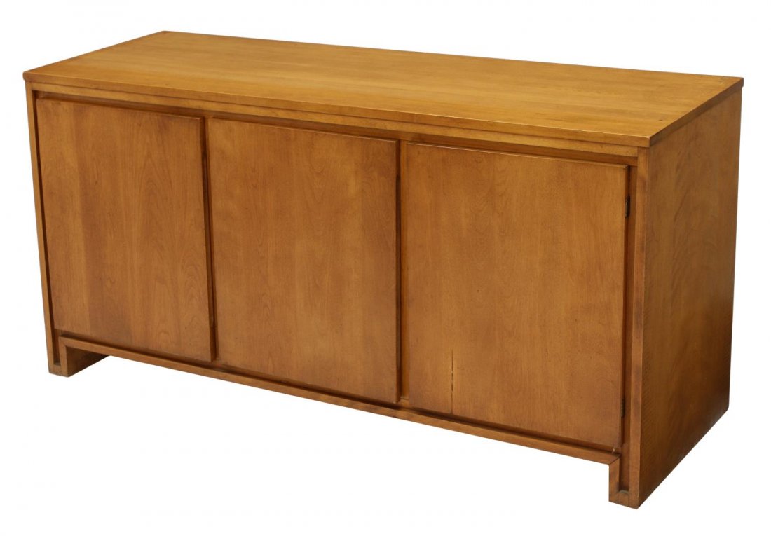 RUSSEL WRIGHT MID-CENTURY MODERN CREDENZA: American mid-century modern credenza, design by Russel Wright (American, 1904-1976), a rectangular top over three doors opening to shelved storage, 27"h, 54"w, 18"d Start Price: $200.00