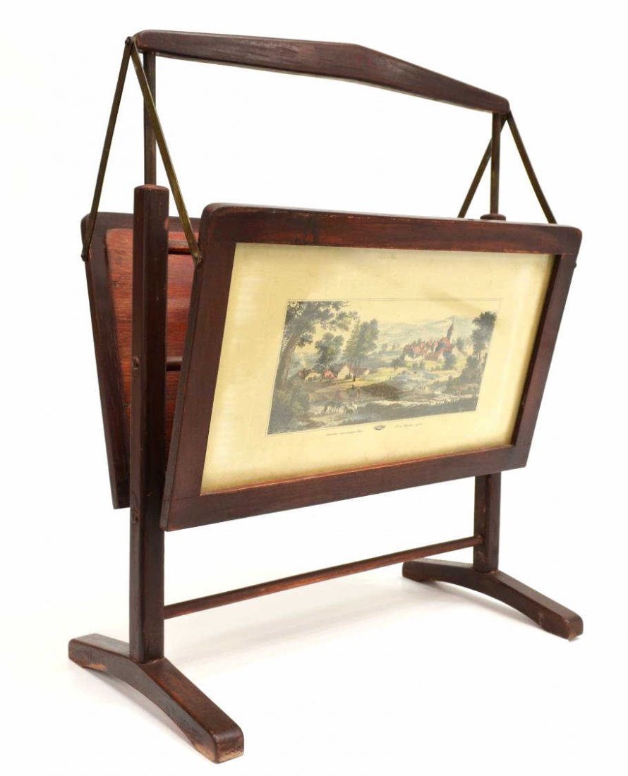 ITALIAN MID-CENTURY FOLDING MAGAZINE RACK: Italian magazine holder, c. 1950's, designed in the manner of Cesare Lacca, painted red wood frames enclosing two color landscape prints, on a trestle base, foxing and toning to the border, approx 25"